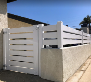 Vinyl fence gate with horizontal slats, showcasing durability and modern design, enhancing outdoor spaces as part of GNG Vinyl's fencing solutions.