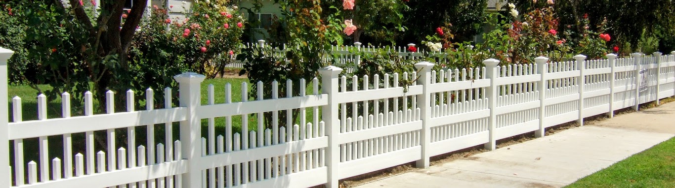 Picket fence in front of flower bed